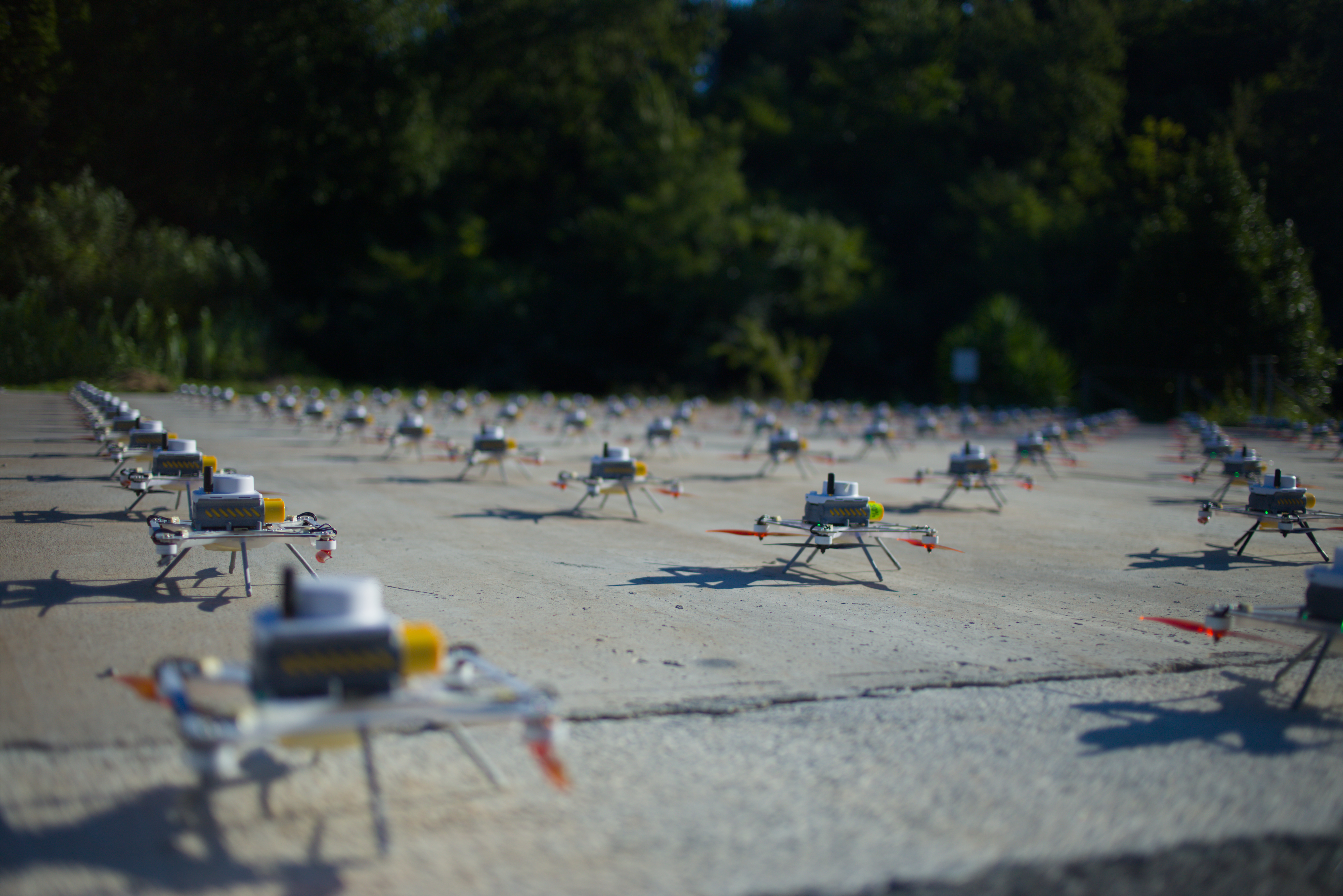 Tilt-shift view of LuminousBee drones ready for takeoff