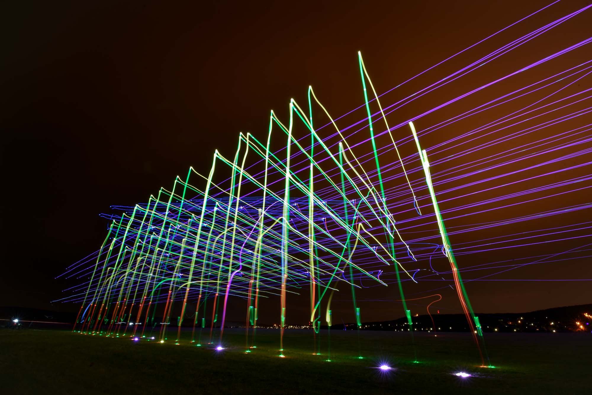 Light painting drone show — long exposure trails of luminous drones
